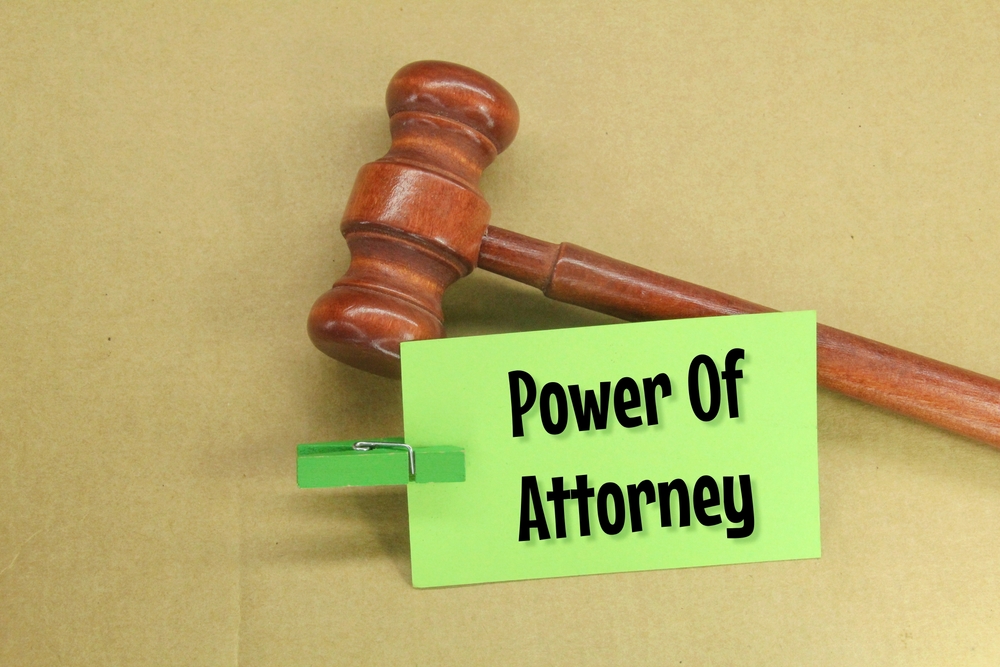 A gavel beside a card reading Power Of Attorney